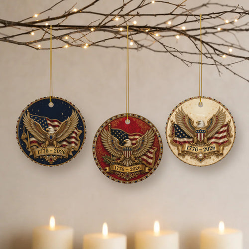 America's 250th Christmas ornaments in navy, garnet and ivory hanging from lit twigs with candles