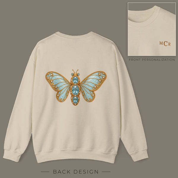Back of sand sweatshirt with jeweled aquamarine hoverfly brooch design; inset shows the front with personalized monogram on the left chest
