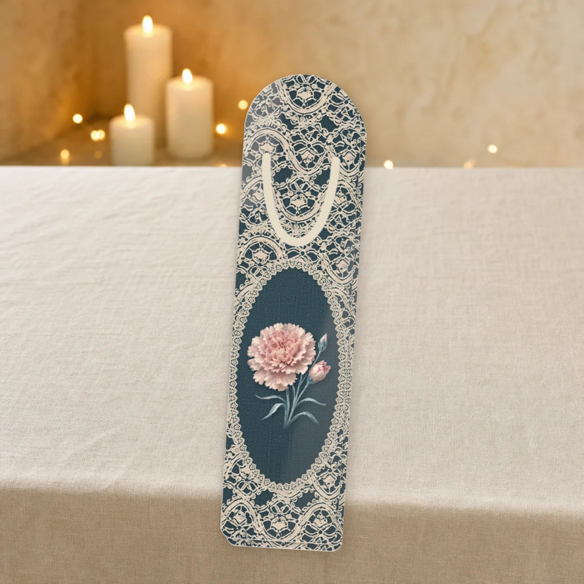 Carnation birth flower metal bookmark with lace design on a linen table