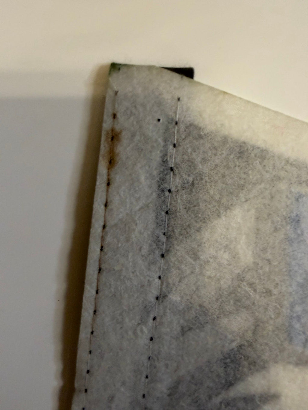 Light stain along header stitching on back