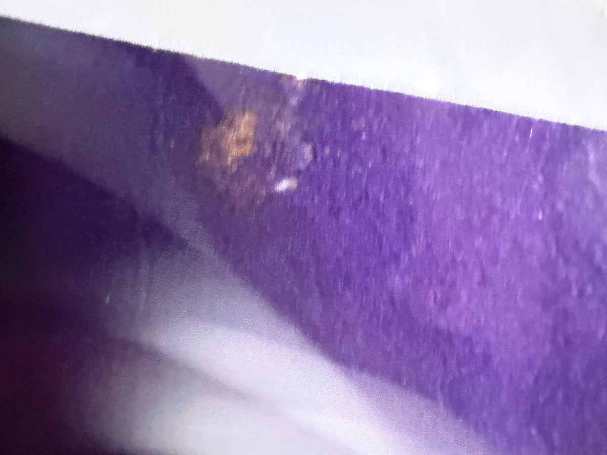 Small discolored spot near top edge