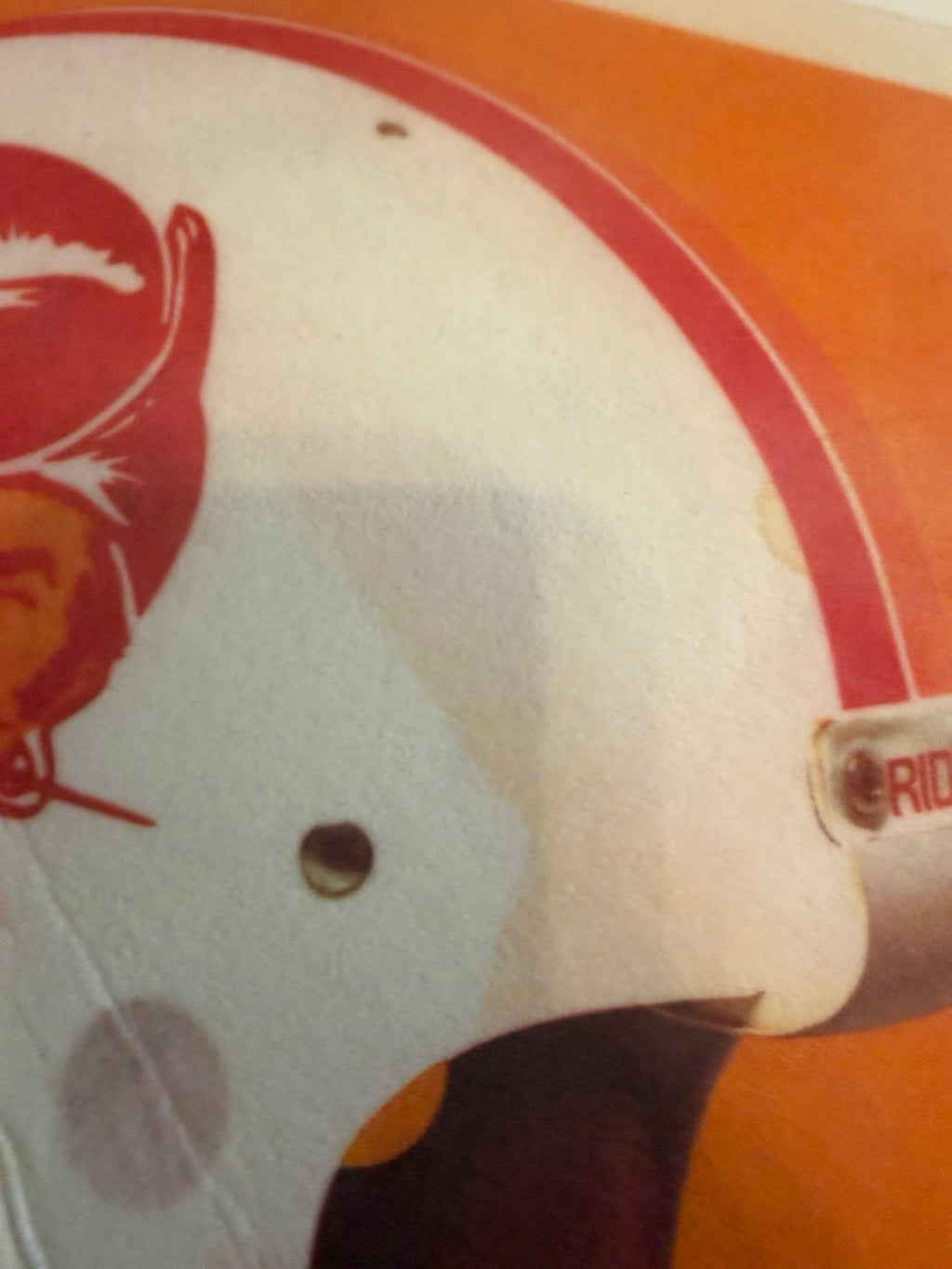Helmet close-up showing tan stain