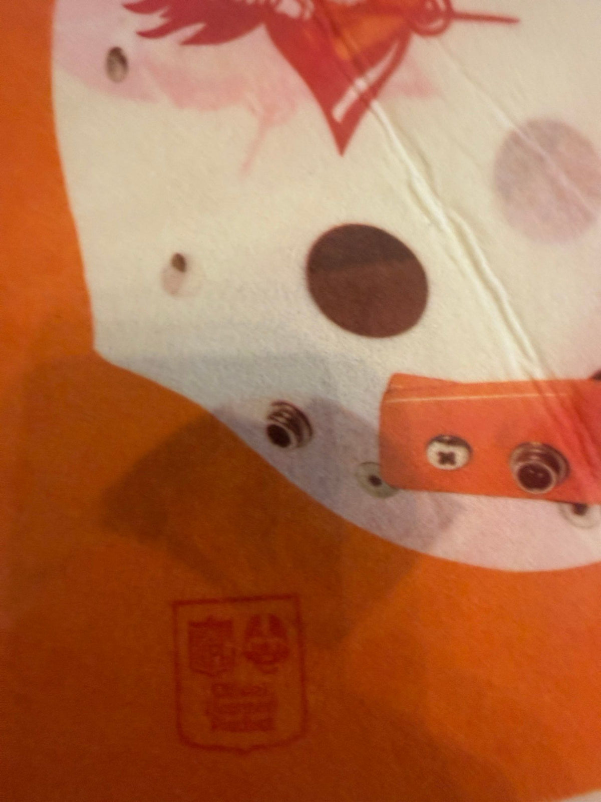 NFL shield and gray smudge on orange panel
