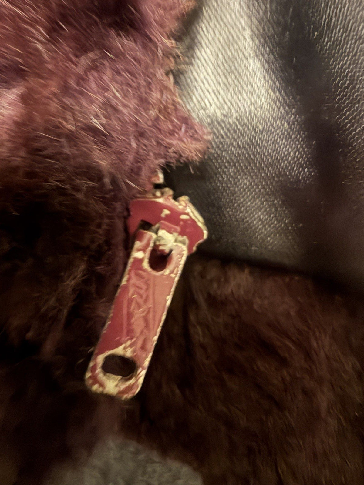Chipped paint on vest zipper pull