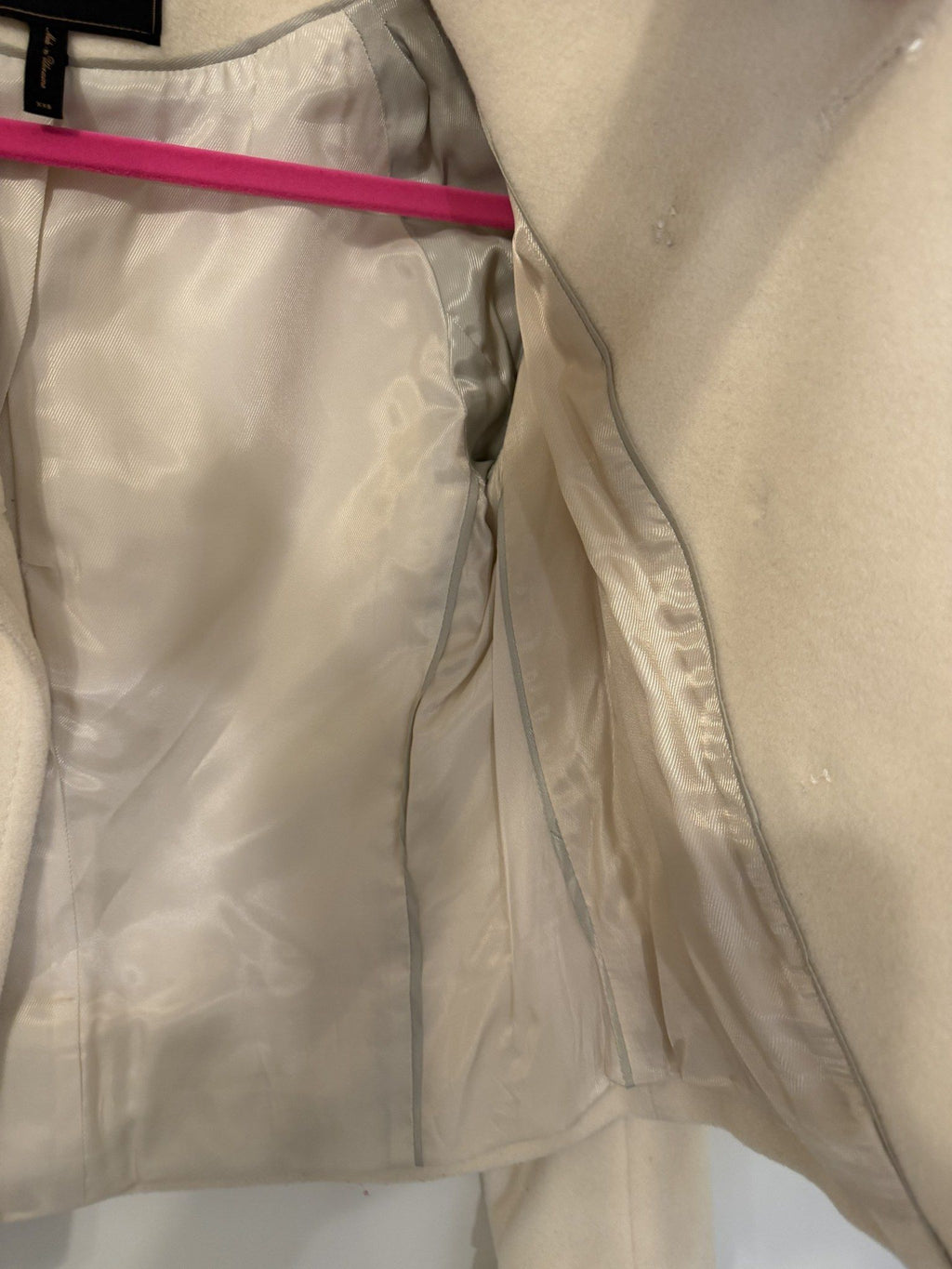 Small white thread marks near the front buttons