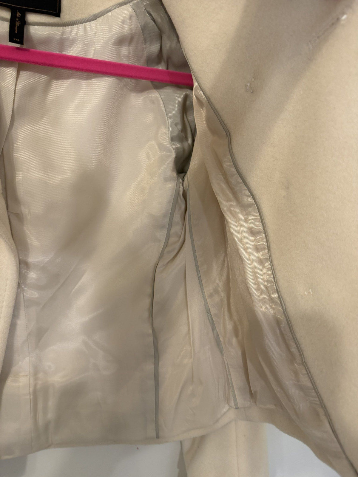 Small white thread marks near the front buttons