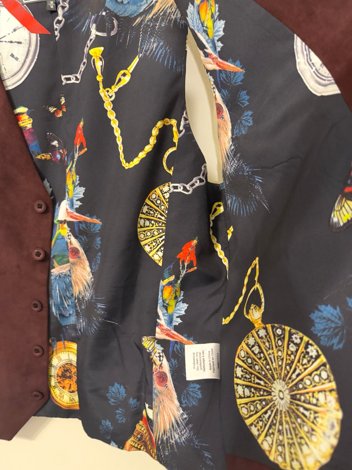 Close-up of pocket watch and chain lining print