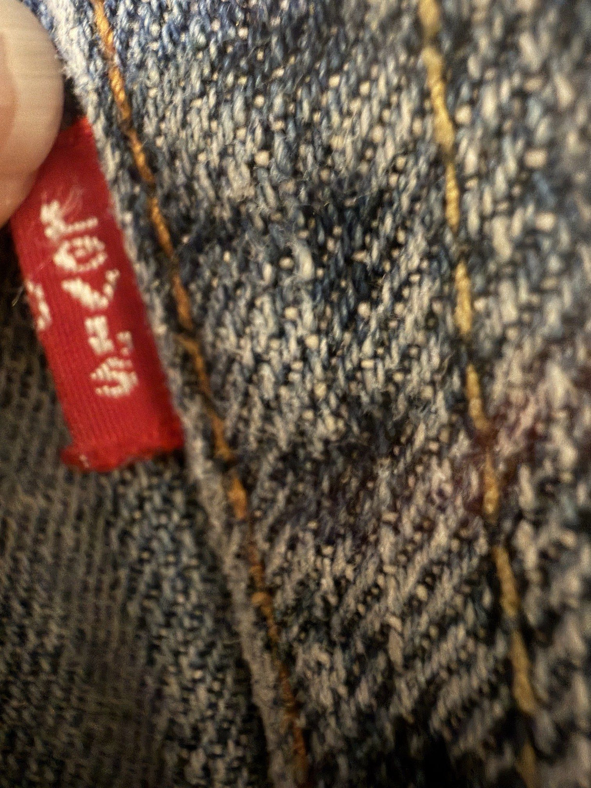 Red tab and back pocket seam close-up