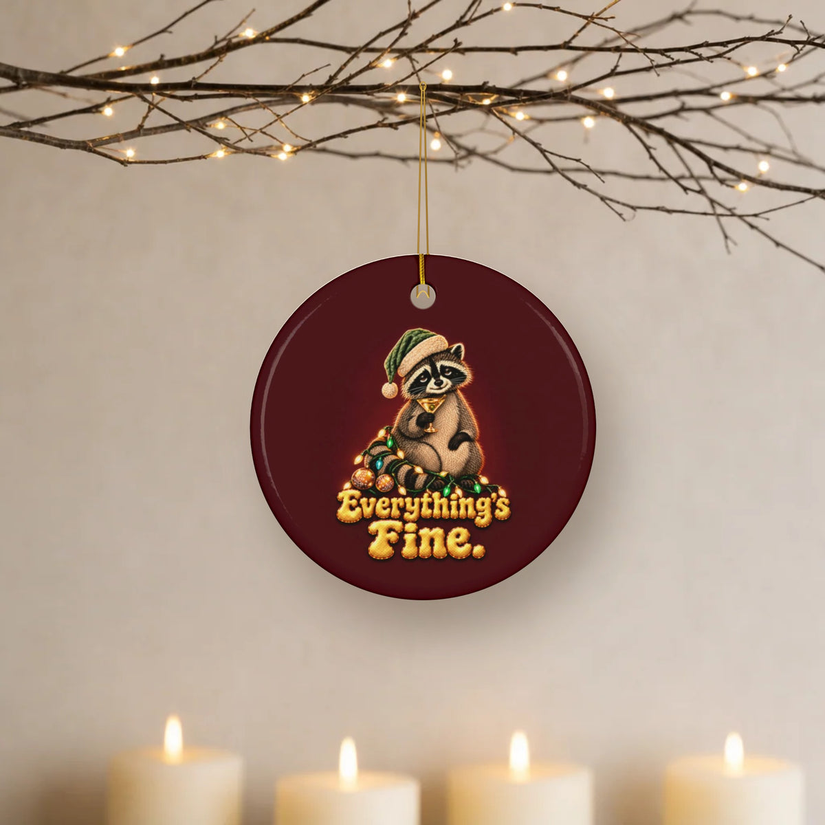 Everything's Fine raccoon ceramic Christmas ornament hanging from lit twigs with candles