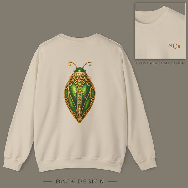 Back of sand sweatshirt with jeweled peridot beetle brooch design; inset shows the front with personalized monogram on the left chest
